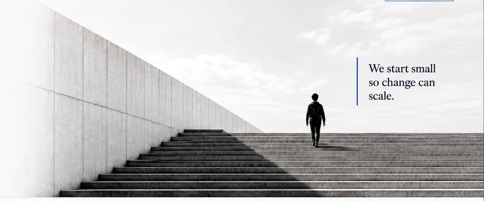 Monumental concrete stairs with a small figure walking upward.