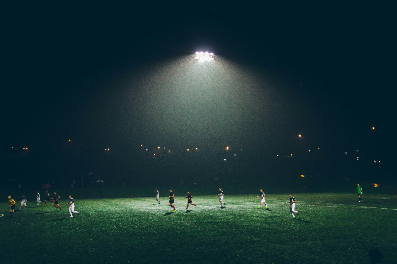 A football resting on a grass pitch