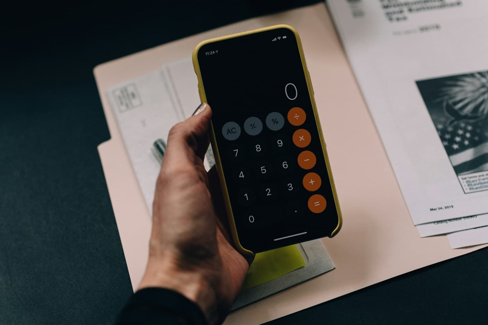 A calculator, notebook and coffee on a planning desk
